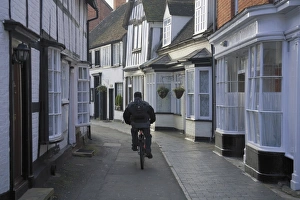 Midland Prints: Man cycling along narrow street, Alcester, Warwickshire, Midlands, England