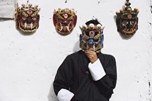 Images Dated 6th October 2009: Man displaying traditional masks, Thimphu, Bhutan, Asia