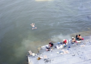 Images Dated 19th October 2009: Man doing early morning yoga excercises in the water near the dhobi (washing) ghats