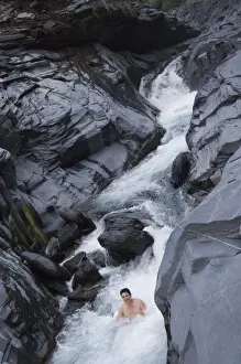 Washin G Prints: Man enjoying natural hot river water of Tona hotspring bath resort