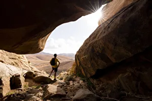 Sandstone Gallery: Man enjoying the view standing inside the sandstone canyons, Barranco de las Penitas