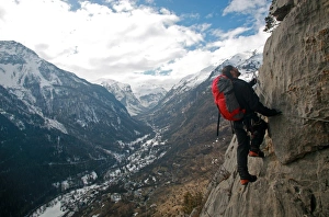 Images Dated 22nd February 2007: A man on a via ferrata route high above the tiny village of Fressinieres