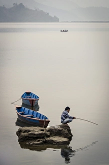 Fishing Rod Prints: A man fishing on Phewa Tal (Phewa Lake), Pokhara, Nepal, Asia