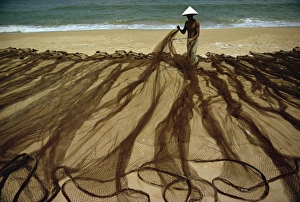 Fishing Net Prints: Man laying out fishing nets on bank of the Dingun River