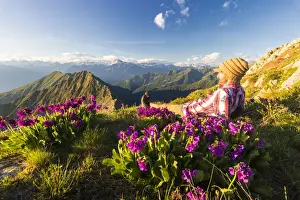 Thoughtful Prints: Man lying down on top of Monte Azzarini looks to Monte Disgrazia and Monte Pedena