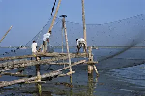 Fishing Net Prints: Man operating large Chinese fishing nets at Fort Cochin