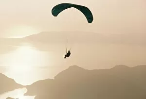 One Man Only Collection: Man paragliding over the Mediterranean coast