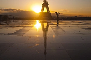 Musical Instrument Prints: A man playing a trumpet in front of the Eiffel Tower, Paris, France, Europe