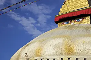 Stupa Prints: Man praying in front of the dome of Boudha (Bodhnath) (Boudhanath) stupa
