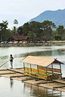 Images Dated 16th June 2010: Man punting bamboo raft on Situ Cangkuang lake at this village known for its temple, Kampung Pulo