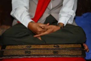 Man reading Buddhist scriptures, Golden temple, Patan, Nepal, Asia