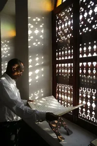Qatar Prints: Man reading the Koran in a Doha mosque, Doha, Qatar, Middle East