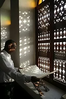 Images Dated 30th July 2007: Man reading the Koran in a Doha mosque, Doha, Qatar, Middle East
