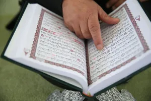 Human Hand Prints: Man reading the Quran in a mosque, Bussy-Saint-Georges, Seine-et-Marne, France, Europe