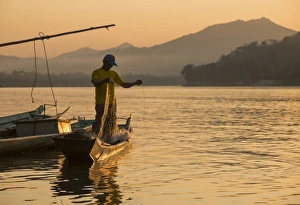 Fishing Net Prints: Man reeling in fishing net on Mekong River