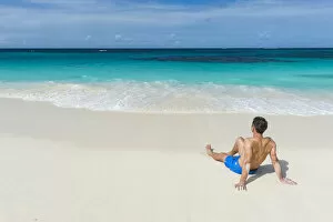 Contemplation Gallery: Man relaxing on the world class Shoal Bay East beach, Anguilla, British Oversea territory