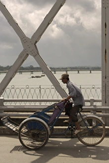 Access Prints: Man riding a Cyclo over bridge, Vietnam, Indochina, Southeast Asia, Asia