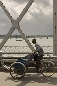 Man riding a Cyclo over bridge, Vietnam, Indochina, Southeast Asia, Asia