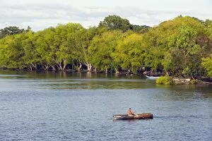 Images Dated 15th December 2010: Man rowing a boat on Ometepe Island, Lake Nicaragua, Nicaragua, Central America