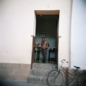 Mature Adult Prints: Man with no shirt on in shop, Trinidad, Cuba, West Indies, Central America