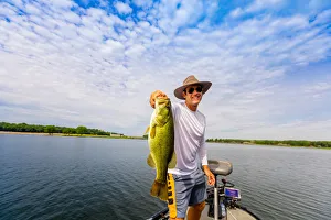 35 39 Years Gallery: Man showing off his big catch of the day fishing on Yellowstone River, South Dakota