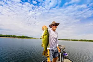 Mid Adults Prints: Man showing off his big catch of the day fishing on Yellowstone River, South Dakota