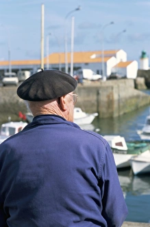60 65 Prints: Man sitting on the quayside, Port Joinville Commune, Ile d Yeu, Vendee