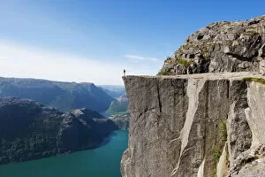 One Man Only Collection: Man standing on Preikestolen (Pulpit Rock) above fjord, Lysefjord, Norway