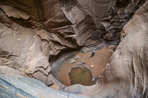 Moab Prints: Man standing in a slot canyon after canyoneering