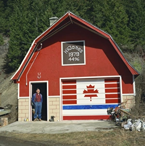 Canadian Culture Prints: A man stands in the doorway beneath two lucky horseshoes