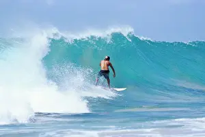 Pernambuco Prints: Man surfing at Praia do Boldro, Parque Nacional de Fernando de Norohna