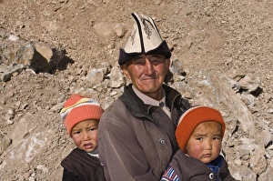 Donkey Prints: Man with twins in the mountains near Sary Tash, Kyrgyzstan, Central Asia, Asia