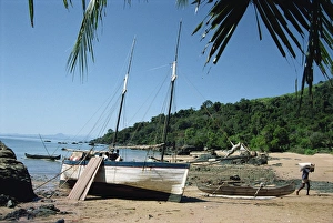 Unloading Prints: Man unloading rice from boat onto beach