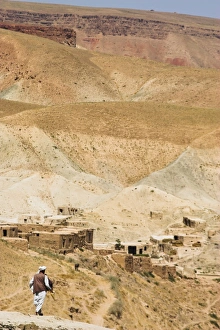 Man walking down mountain road, between Herat and Maimana, after Subzak Pass