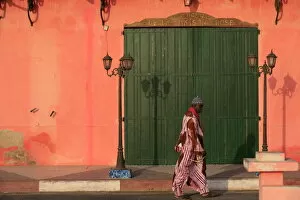 Images Dated 30th January 2007: Man walking past a pink house, St. Louis, Senegal, West Africa, Africa