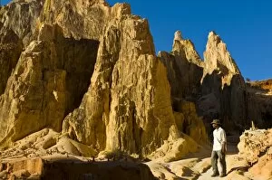 Man walking through strange looking sandstone formations, Ankarafantsika National Park