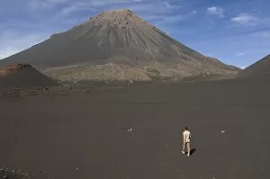 Man walking towards volcano on Fogo, Cape Verde Is lands , Africa