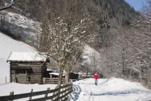 Tracks Prints: Man walking on Winterwanderweg cleared trail along Alpine valley with snow in winter