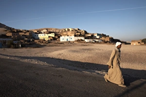 West Bank Prints: A man walks past a village on the West Bank of Luxor, Egypt, North Africa, Africa