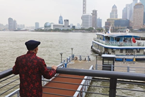 Huangpu River Prints: A man watching ferries crossing the Huangpu River, Shanghai, China, Asia