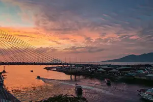 Voyages Prints: Manado port and Soekarno Bridge with Manadotua Island beyond at sunset in provincial capital of Sulawesi's far