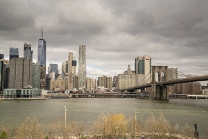 East River Prints: Manhattan skyline and Brooklyn Bridge on a cloudy day