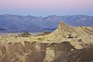 Manly Beacon and the Siltstone eroded foothills formations at Zabriske Point at sunrise