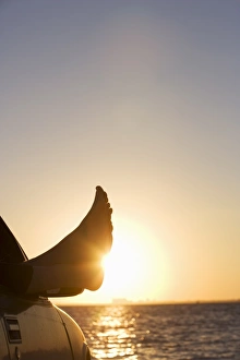 Shoeless Prints: Mans feet in car at sunset in Key Byscaine