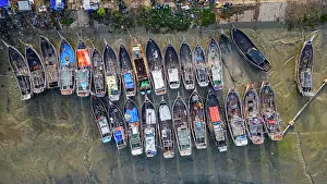 Fishermen Prints: Market activity at Fish market in Chittagong with boats lined up and people engaged in trade