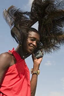 Masai man talking on mobile phone, Masai Mara, Kenya, East Africa, Africa