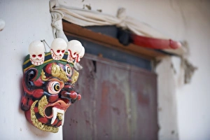 Images Dated 5th October 2009: Mask and phallus hanging on a door to protect its occupants, near the temple of the Divine Madman