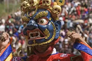 Images Dated 7th April 2009: Masked dancer at religious festival with many visitors, Paro Tsechu, Paro, Bhutan, Asia