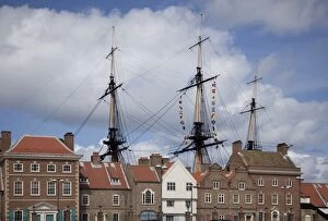 Mas ts and rigging of HMs Trincomalee, Britis h Frigate of 1817, s een above old buildings at Hartlepools Maritime