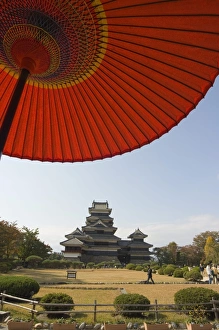 Matsumoto Castle under red parasol